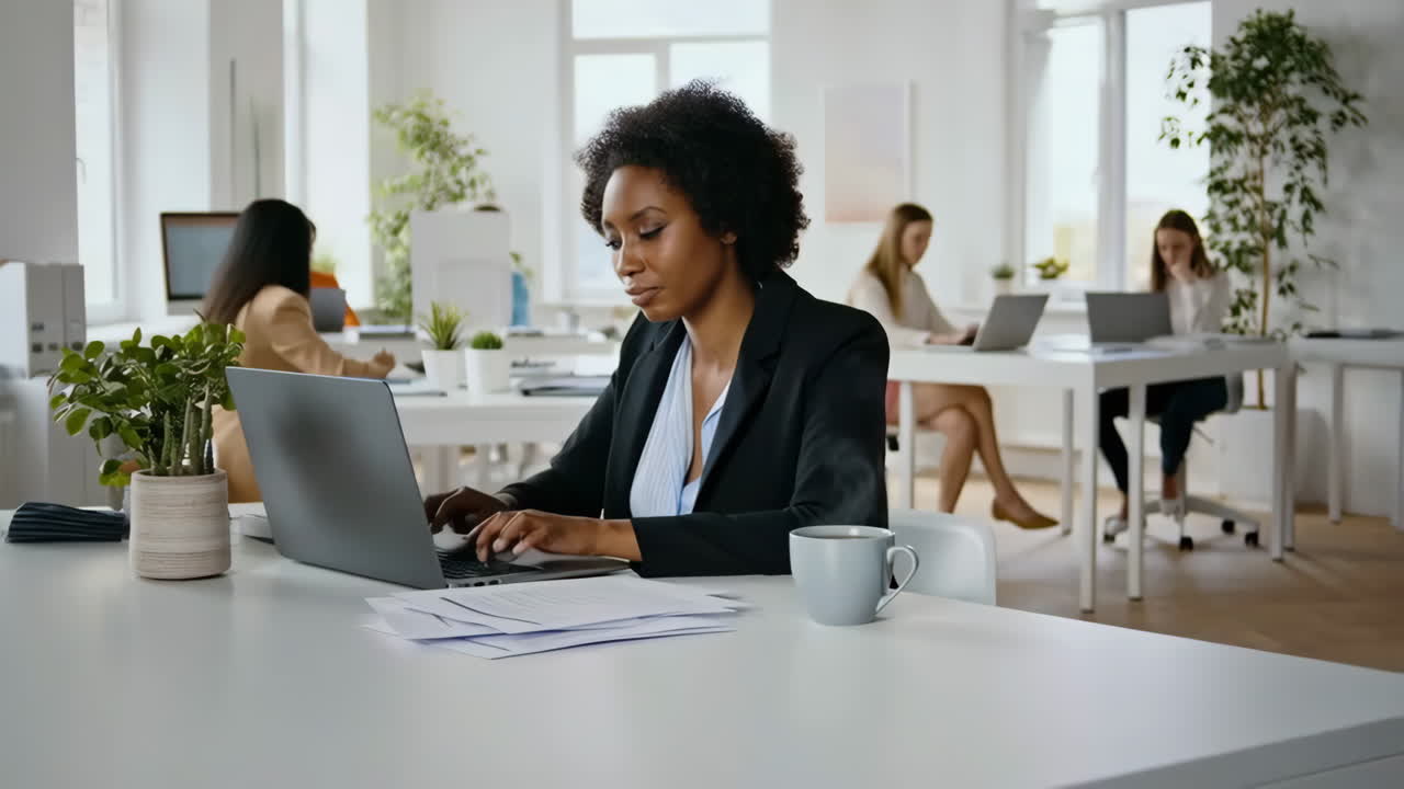 Businesswoman Working on Laptop in Modern Office