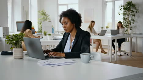 businesswoman working on laptop in modern office