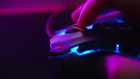 close up shot of a hand scrolling the mouse wheel while playing games and clicking on a computer