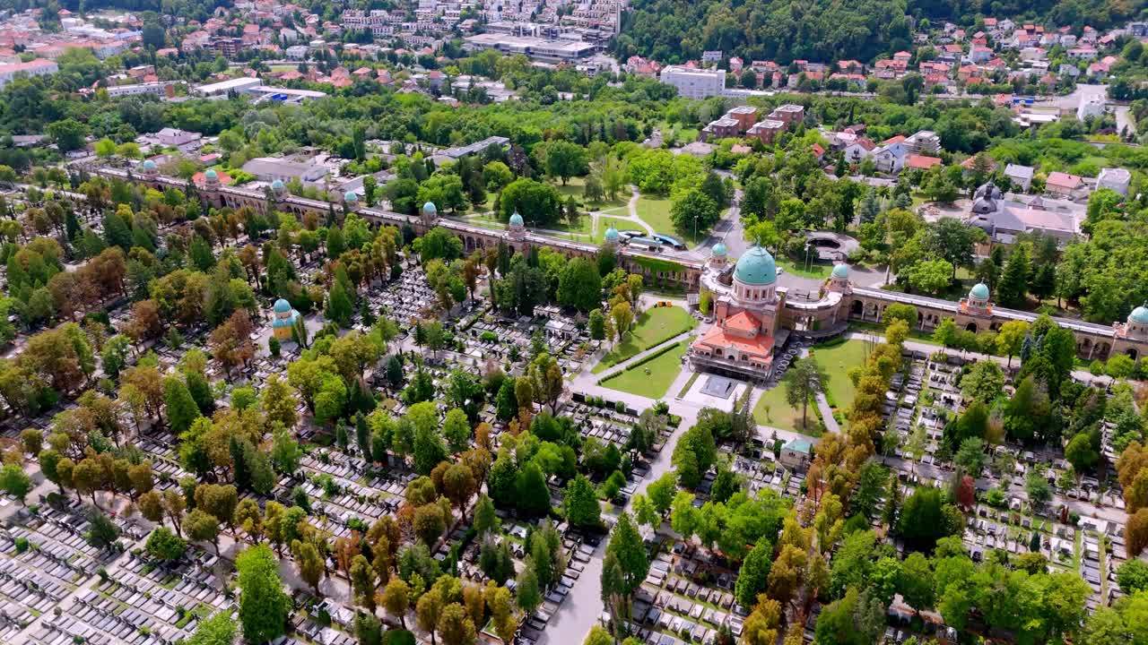 Aerial drone view of Mirogoj Cemetery in Zagreb, Croatia. green domes, ivy-covered arcades, and symmetrical paths
