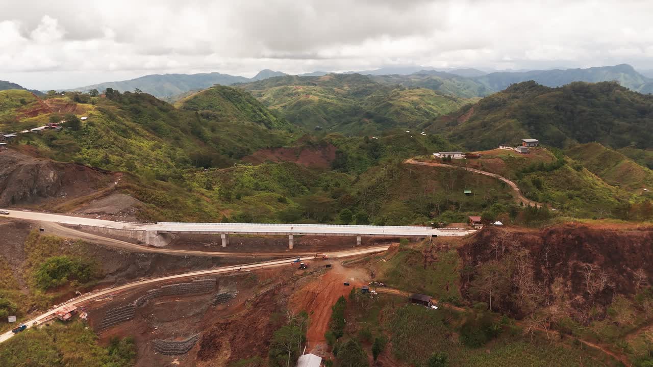 Aerial drone footage of a newly built mountain bridge and surrounding green landscape in the Philippines. Perfect for infrastructure, transportation, and cinematic projects