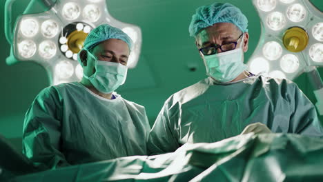 surgeons performing surgery in operating room