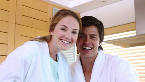 A-couple-in-bathrobes-using-video-chat