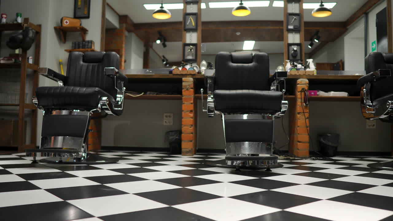 Interior of the men's Barber shop with brick walls and leather chairs with chrome handles