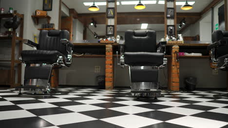 interior of the men's barber shop with brick walls and leather chairs with chrome handles