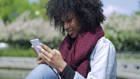 Cheerful-girl-using-smartphone