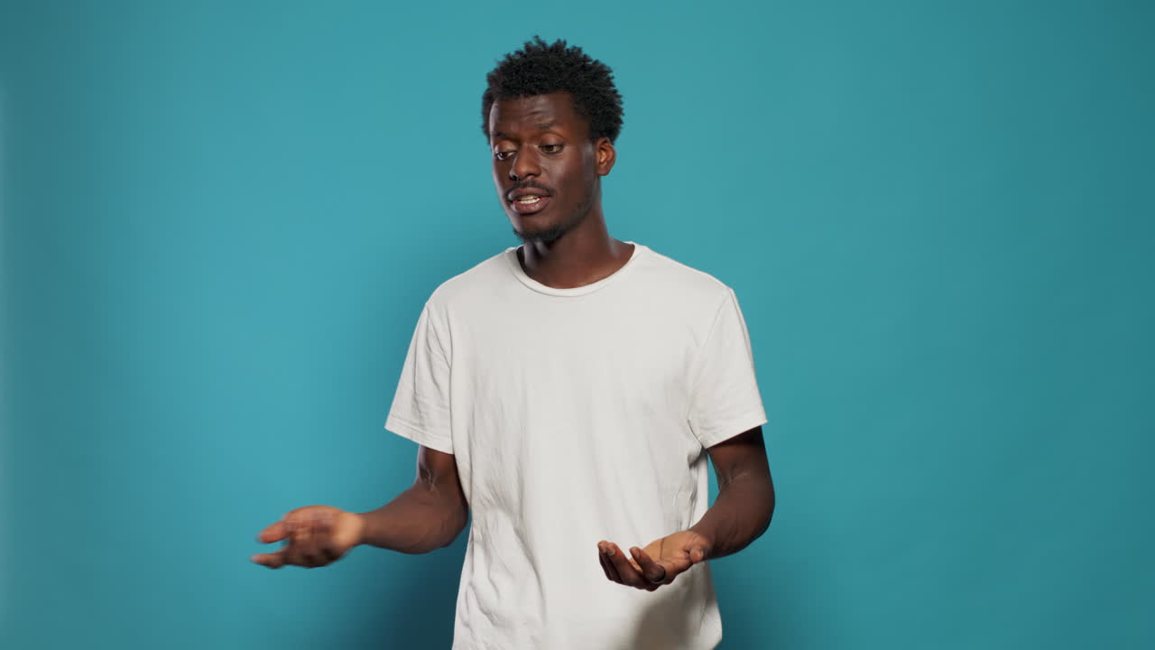 Young adult talking and doing hand gestures on camera