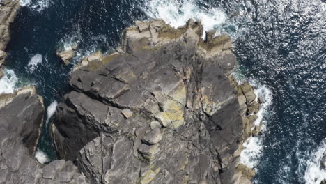 aerial - cliffs next to the ocean, dingle, county kerry, ireland, forward top down