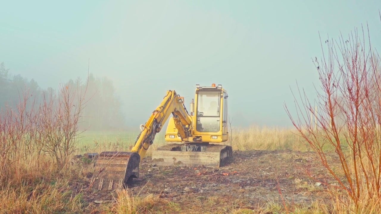 Resting Tracked Hydraulic Excavator Against A Misty Nature Background. Static Shot