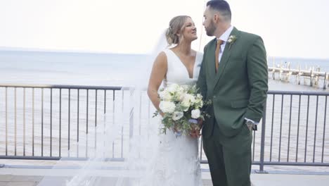 Bride-and-groom-hold-hands-and-look-at-each-other