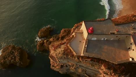 aerial view of a lighthouse and fortress on a cliffside