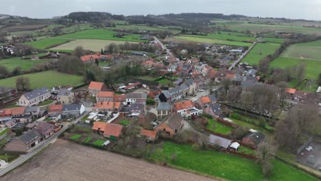 descending drone flight shows the entire village of westouter in the flemish west flanders in belgium