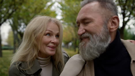 Portrait-of-cheerful-married-couple-having-fun-outdoors.-Smiling-caucasian-man.