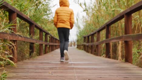 Slow-motion-of-a-child-walking-on-a-walkway