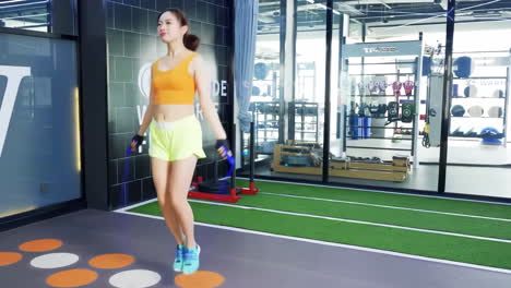 sport fitness, woman and skipping with rope at the gym for health cardio exercise, training or workout indoors