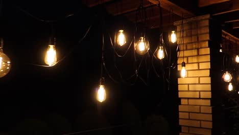 hanging light bulbs with yellow-orange glowy light at night