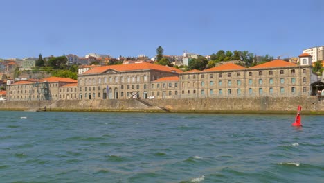 view from tourist boat sailing douro river in porto, portugal - pov