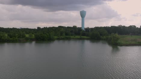 light blue water tower and brays bayou cutting through alief, houston – drone view