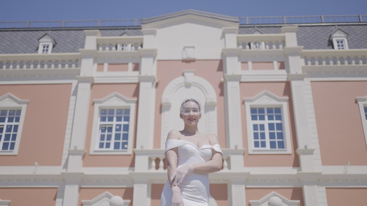 Woman in a White Dress in Front of a Palace