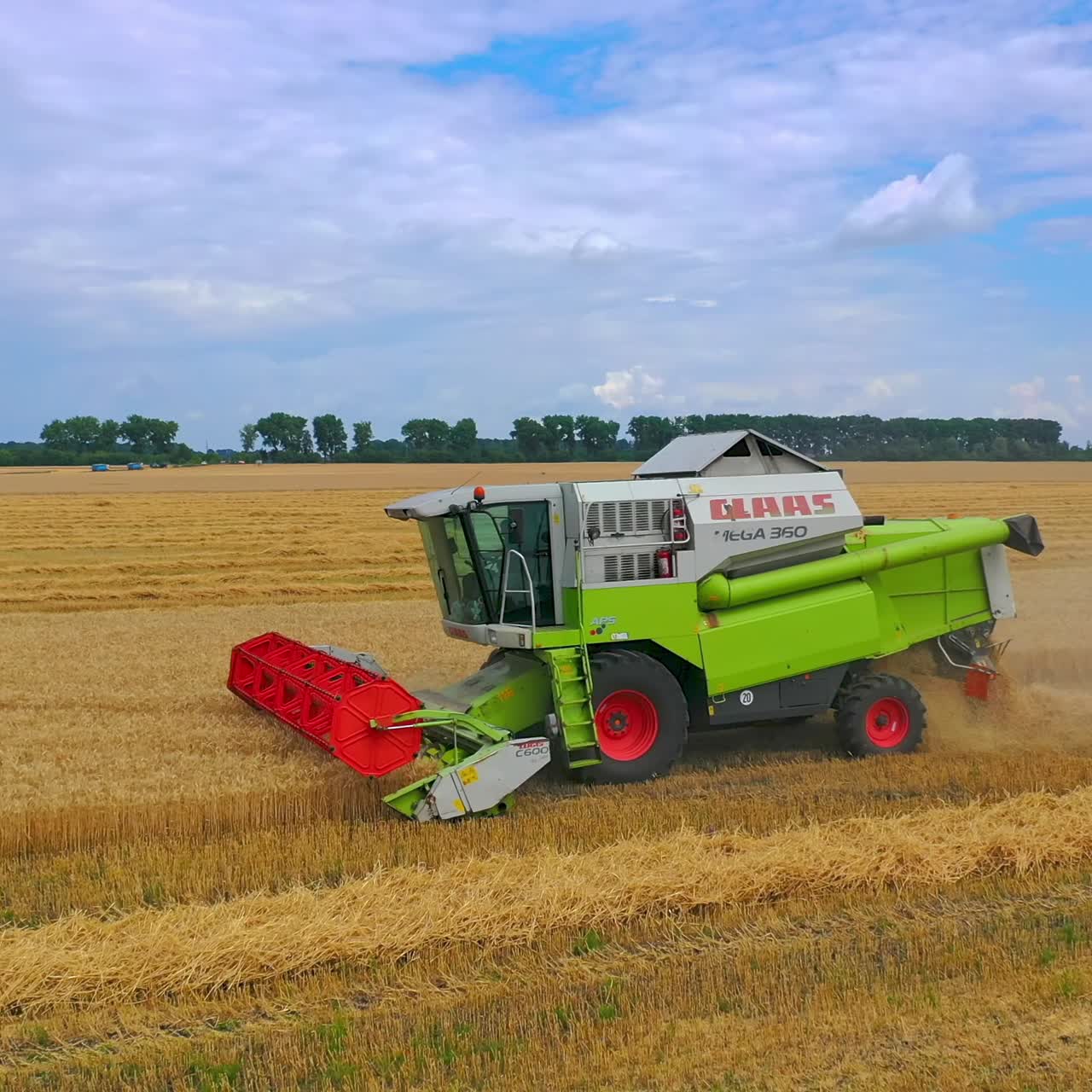 Aerial view of harvester in fields