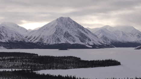 snowcapped mountain ridge during winter in kathleen lake in yukon, canada. aerial drone shot