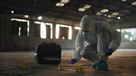 forensic scientist collecting evidence at a crime scene