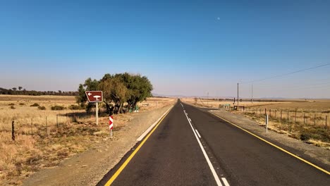 Isolated-picnic-stop-on-the-side-of-a-tar-road-in-Africa,-surrounded-by-tranquil-nature-and-shady-trees