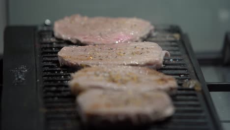 Flipping-steaks-cooked-on-electric-grill