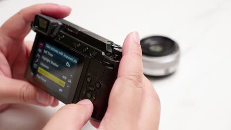 male hand using camera to take photos of items on white background to sell in online market