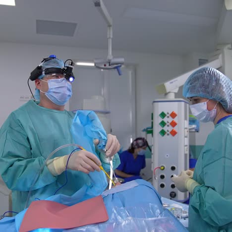 surgeon inserts special tools into patient's nose. otolaryngology operation in the modern equipped operation room