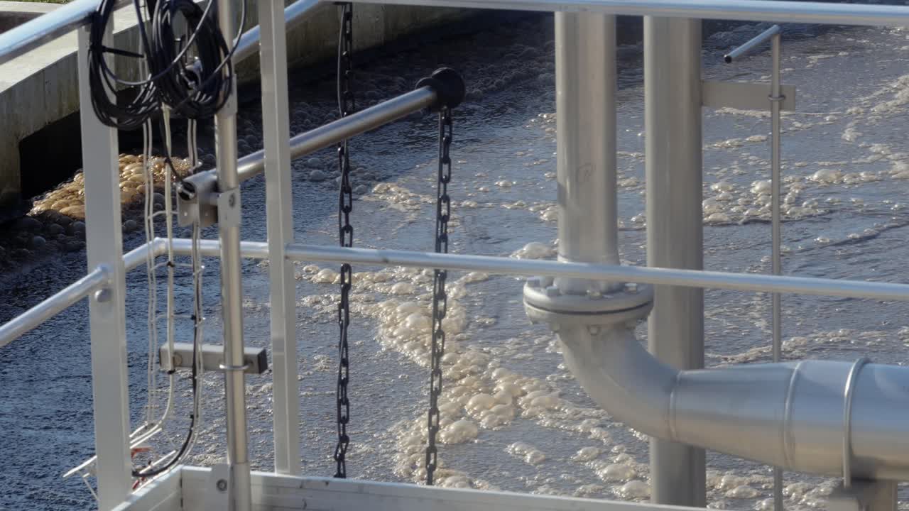 Wastewater treatment plant with metal structures, symbolizing industrial cleanup, gray tones