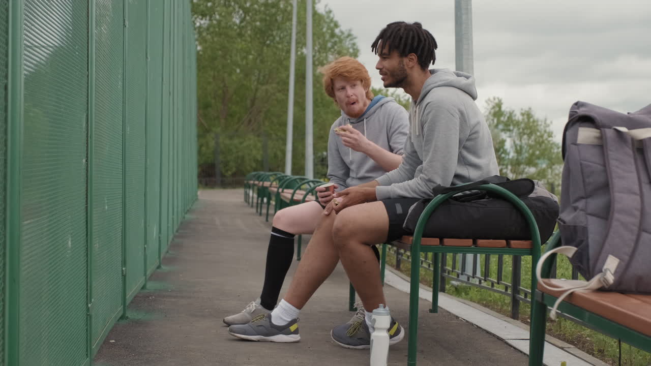 Male Friends Resting after Playing Streetball