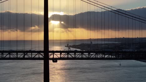sunset skyline of 25th april bridge at lisbon in district of lisbon portugal. sunset cityscape. cable bridge scene. 25th april bridge at lisbon in portugal. highway road landscape. cable bridge