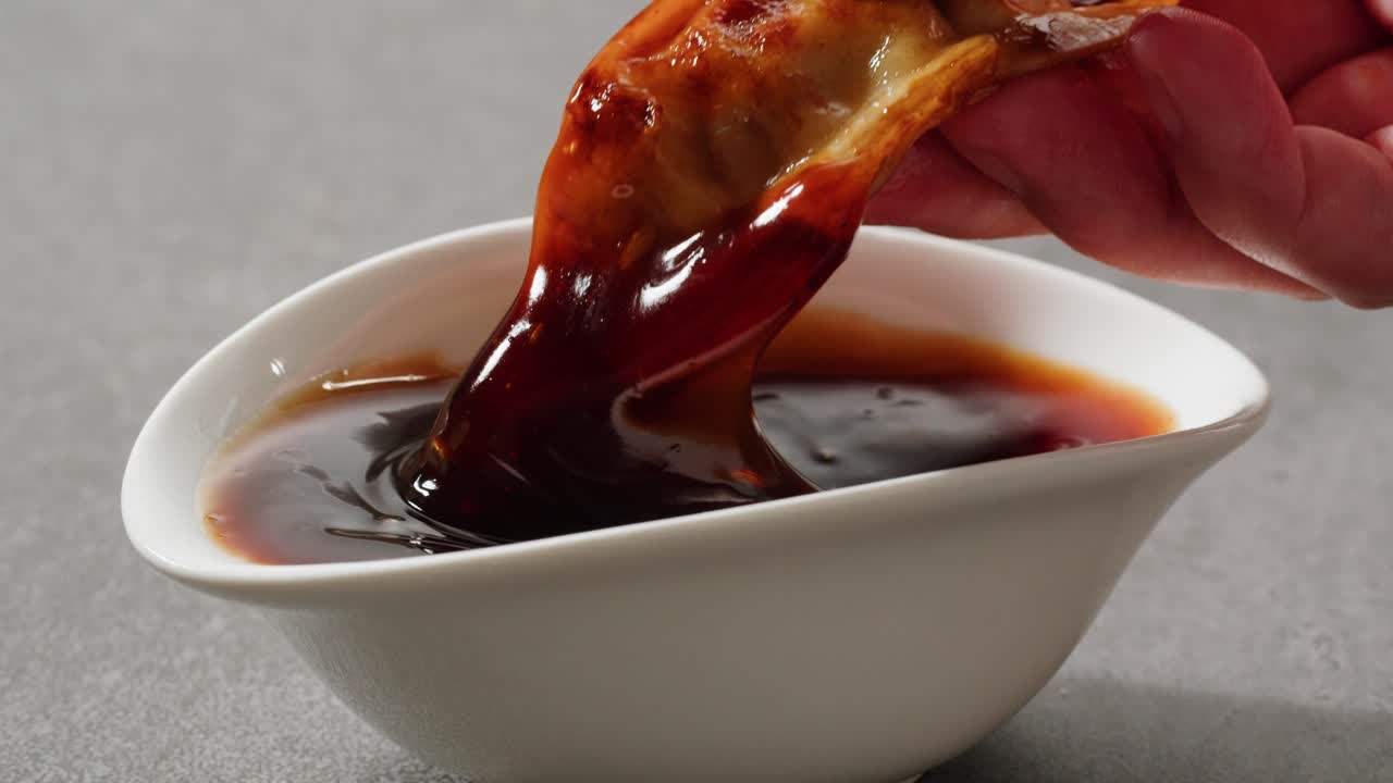 Dipping dumplings in soy sauce