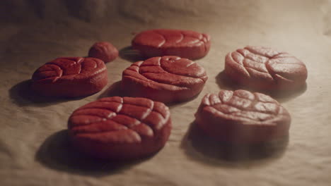 A-bunch-of-red-cookies-in-the-oven-raising-with-the-heat,-static-close-up