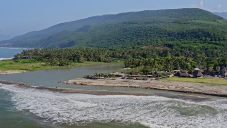 aerial: river estuary meeting ocean, low tide and sea level