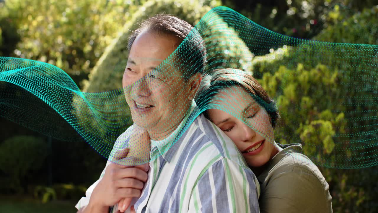 Woman coming and embracing man, teal ribbon sweeping around them in garden, ad showing comfort