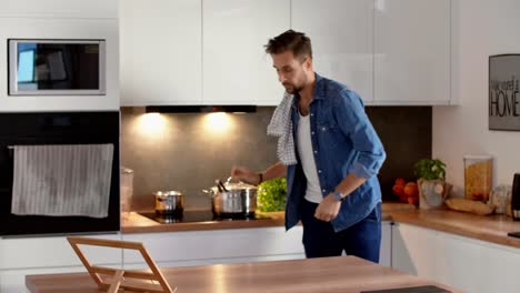 Man-using-mobile-phone-in-the-kitchen