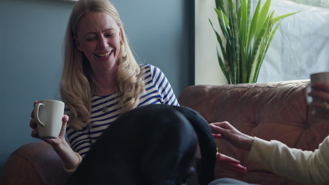 People indoors sitting on couch