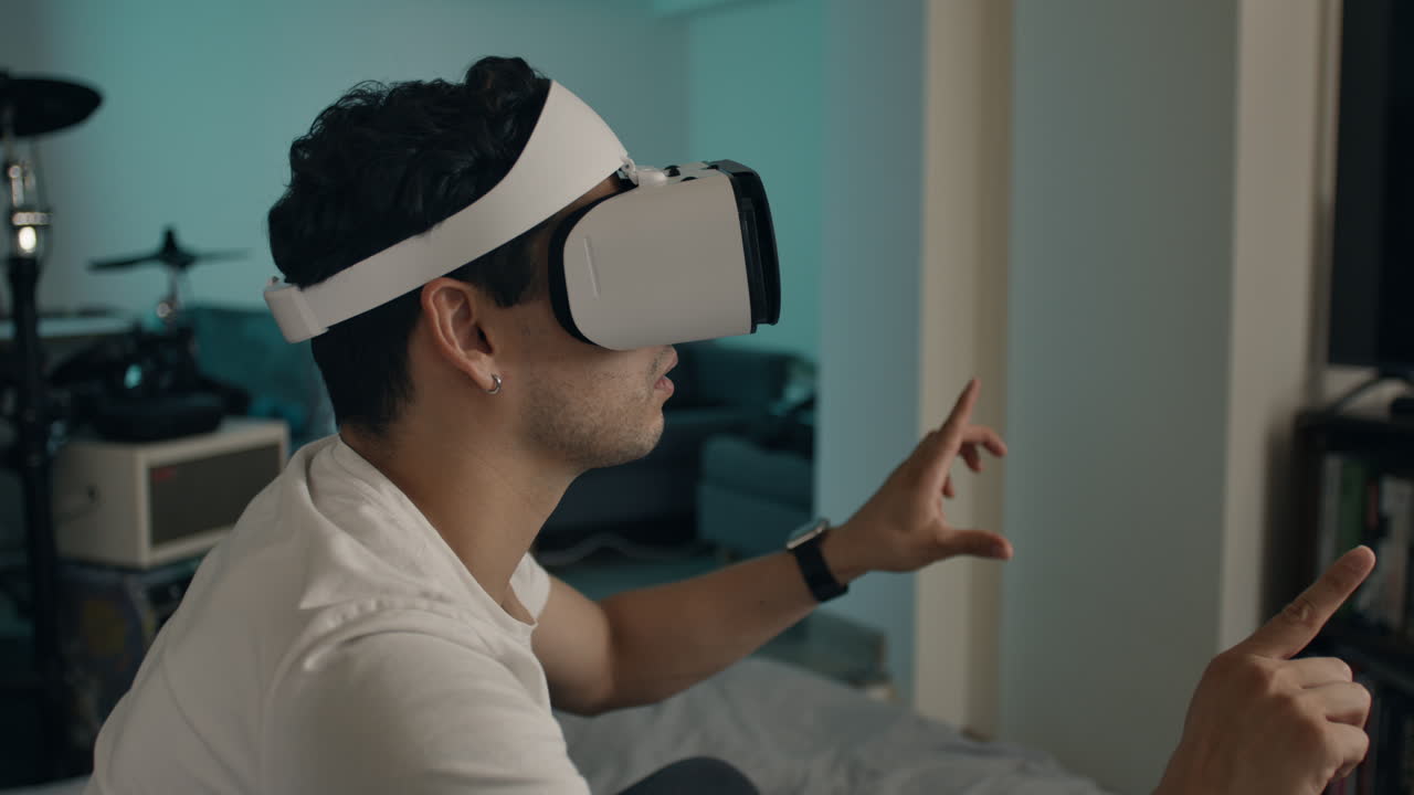 Man uses VR headset and gestures at digital interface at home in amaze