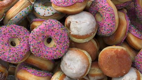 falling different donuts on a pink background