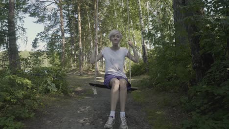 woman swinging in a forest