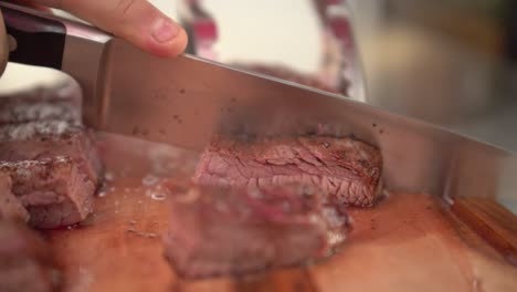 chef cutting hot medium rare flank beef, slow motion