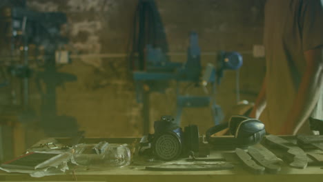 animation of mask over caucasian male worker walking in workshop