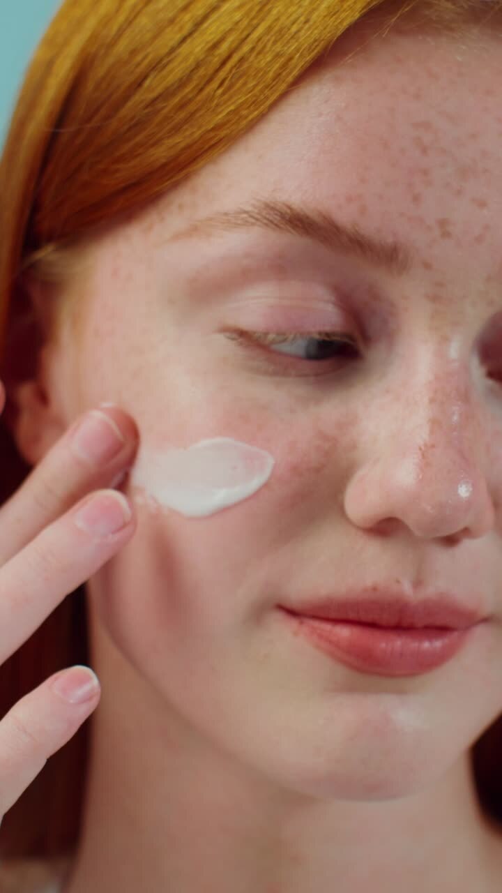 Woman Applying Face Cream