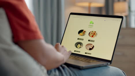 manos, sofá y pantalla de portátil para la entrega de alimentos