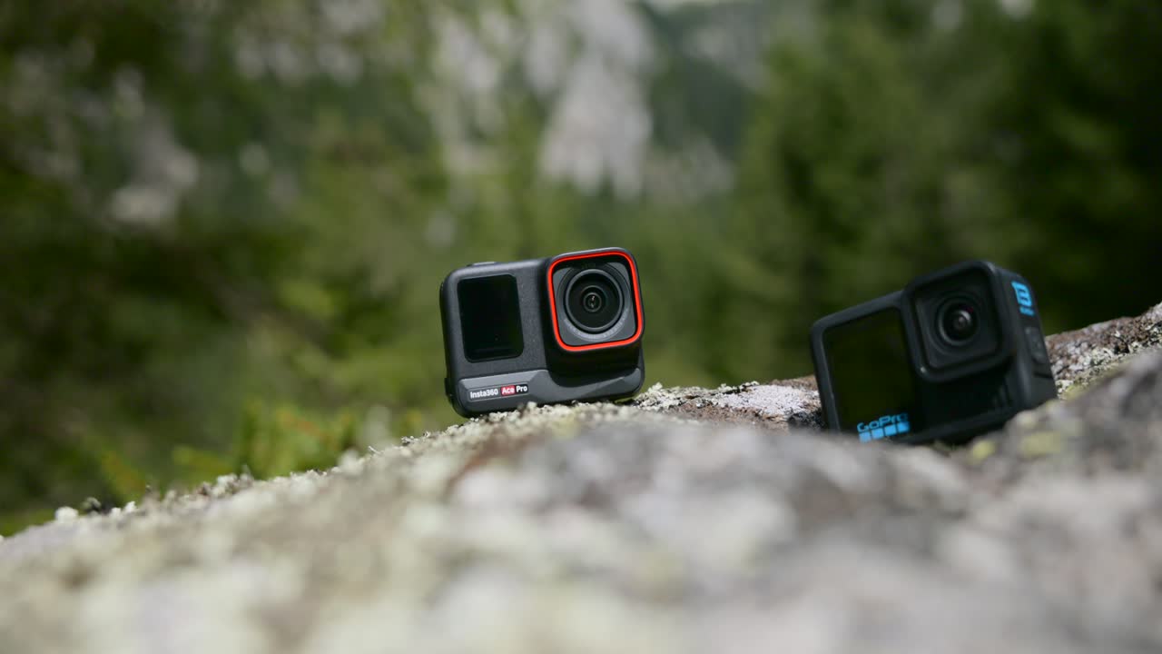 Two action cameras placed on rocks, capturing the serene outdoor environment. Perfect for highlighting new technology and adventure photography equipment.