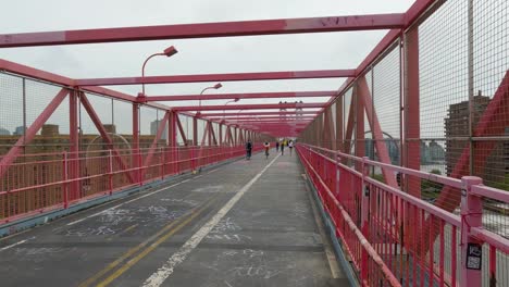 walking over the williamsburg bridge in new york city