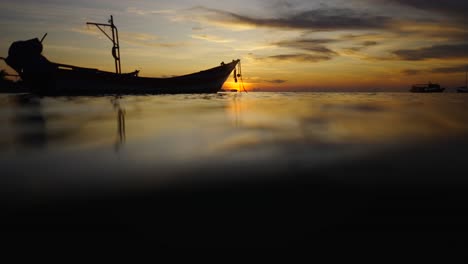 sunset silhouette of a boat on calm water