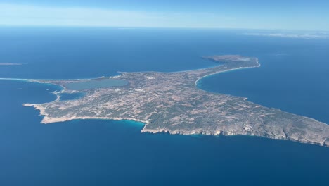 Formentera-Island,-in-Spain,-aerial-panoramic-view-shot-from-a-jet-cabin-departing-from-Ibiza-Island